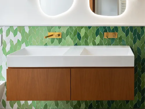 Bathroom wall tiles with a green and white leaf pattern